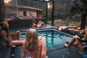 a group of people sitting around a swimming pool at Wolf Totem Studio Loft in Pisac