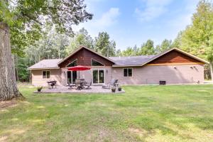 a home with a large yard with a house at Merrifield Vacation Rental with Dock and River Access in Merrifield