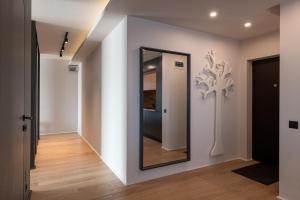 a mirror on a wall in a hallway at Sauna&Jacuzzi Apartment in Cluj-Napoca