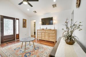 a living room with a table and a tv at New Orleans Duplex Walk to Parks and Restaurants! in New Orleans