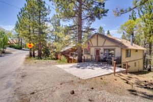 a small house in the woods with a driveway at Rustic Big Bear Lake Cabin Retreat Near Skiing! in Big Bear Lake