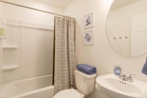 a bathroom with a toilet and a sink and a mirror at 9 Mi to Airport Pet-Friendly Aurora Home with Deck in Aurora +24 photos