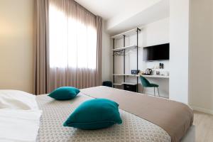 a bedroom with a bed with two pillows on it at La Locanda d'Oro in Monastir