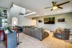 a living room with couches and a ceiling fan at 4 Mi to Bourbon St Spacious Retreat with Wet Bar! in New Orleans