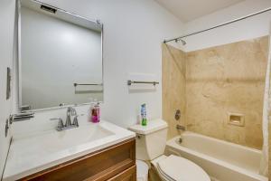 a bathroom with a sink and a toilet and a shower at 4 Mi to Bourbon St Spacious Retreat with Wet Bar! in New Orleans +19 photos