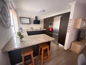 a kitchen with a counter and a sink and a refrigerator at Casa Tata - Apto Icod de los Vinos in Icod de los Vinos