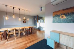 a dining room with a table and chairs at The Box House in Furano