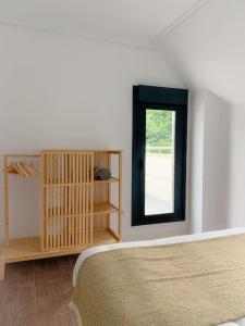 a bedroom with a bed and a window at Atico con espléndida terraza in Comillas