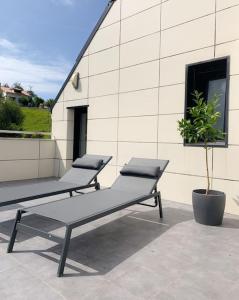 two benches sitting on top of a building at Atico con espléndida terraza in Comillas