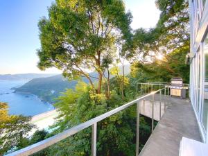 a balcony with a view of the water at White House 熱海 in Atami