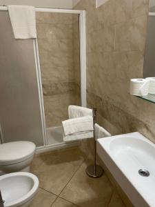 a bathroom with a shower and a toilet and a sink at Siena Fox In in Siena