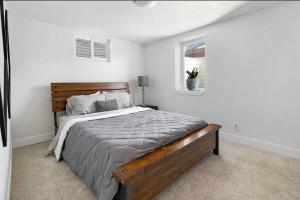 a bedroom with a large bed in a white room at House of Vibes - Dog Friendly in Denver