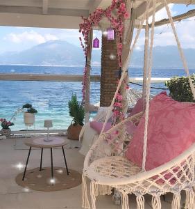a swinging bed with a view of the ocean at Hotel Rodini in Kato Rodini