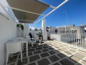 a patio with a table and chairs on a balcony at Casa Sunshine in Ostuni +20 photos