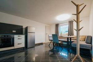 a kitchen and dining room with a table and a dining room at Nockventure Ferienhaus Gnesau in Gnesau