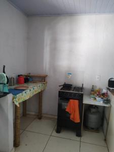 a kitchen with a stove and a table in it at Casa Aloe Vera in Cavalcante
