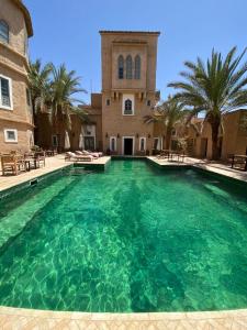 a large swimming pool in front of a building at Le moulin in Taroudant