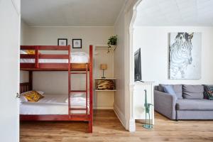 a room with two bunk beds and a couch at MtlVacationRentals - MTL ZOO in Montréal