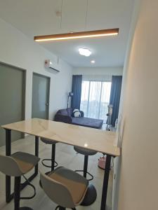 a room with a table and chairs and a bed at Super Comfort 2R2B Luxury Seaview Sandakan in Sandakan
