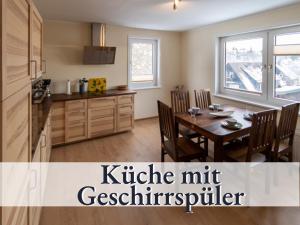 a kitchen and dining room with a table and a kitchennut refrigerator at Haus an der Skiwiese-Braunlage in Braunlage