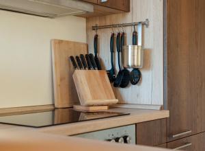 a kitchen with wooden utensils hanging on a wall at Natur Pur Ferienhaus Falkenhagen in Thale