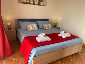 a bedroom with a bed with towels on it at Appartamento La Caletta in La Caletta