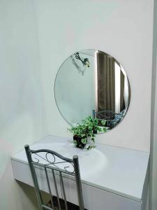 a mirror on top of a table with a plant at NJ's Place, Shore 1 Residences, MOA Complex, Pasay City, Philippines in Manila