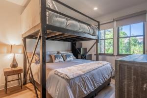a bedroom with two bunk beds and a television at Creekhouse 1583 in Mammoth Lakes