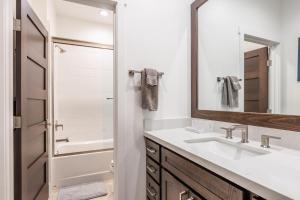 a bathroom with a sink and a mirror at Creekhouse 1583 in Mammoth Lakes +42 photos