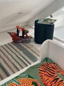 a room with a bed with a toy boat on the floor at Harcombe Barn near Bristol in Bristol