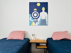 a room with two beds and a picture on the wall at Bonito departamento playa/planta baja in Playa del Carmen +22 photos