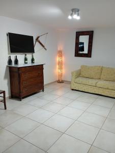 a living room with a couch and a flat screen tv at DON BOSCO 2 in Bari Palese