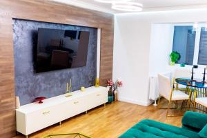 a living room with a large tv on a wall at Lady Suite in Cluj-Napoca