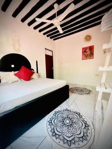 a bedroom with a large bed and a ceiling at Villa Euphoria - Adults Only in Paje