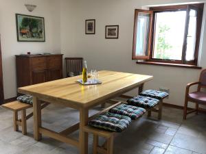 a wooden table in a living room with two chairs at Casa della Meridiana in Clastra +15 photos