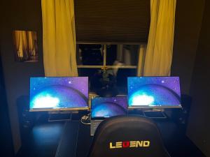 three laptop computers sitting on a table in a room at Day to Day Motel in Borlänge