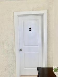 a white door with a small sign on it at Cute Private Room, near the Airport - Free parking - 02 in Miami