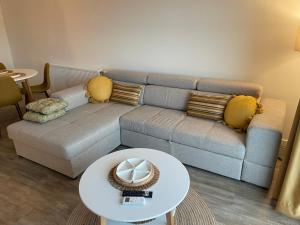 a living room with a couch and a table at Apartman Prodan in Sombor