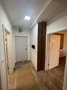 an empty room with a door and a hallway at Apartman Prodan in Sombor