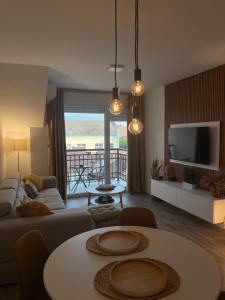 a living room with a couch and a table at Apartman Prodan in Sombor