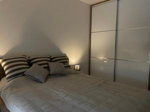 a bedroom with a large bed with two pillows at Apartman Prodan in Sombor