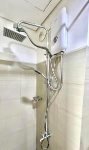 a shower in a bathroom with a shower head at NJ's Place, Shore 1 Residences, MOA Complex, Pasay City, Philippines in Manila