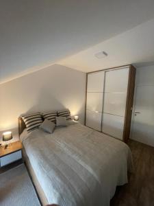 a bedroom with a large bed with two pillows at Apartman Prodan in Sombor
