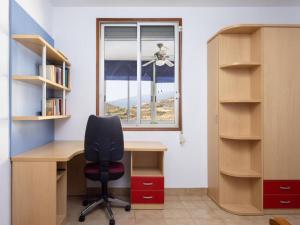 an office with a desk and a chair and a window at Live Tabaiba Decre con piscina in Tabaiba