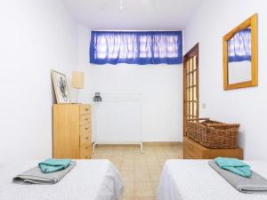 a bedroom with two beds and a mirror and a window at Live Tabaiba Decre con piscina in Tabaiba +33 photos
