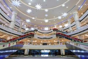 an empty shopping mall with snowflake ceilings at Live Like A Family Home Away From Home in Sharjah