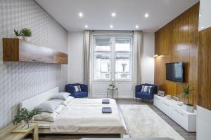 a bedroom with a bed and a tv in it at CCC Apartments in Budapest