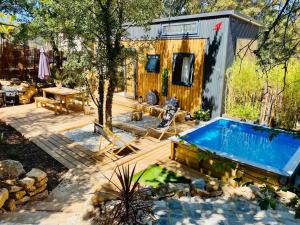 a tiny house with a swimming pool in a yard at Tiny LiLouMaCa Cœur Ste Baume in Plan dʼAups