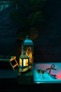 a table with a lantern and two glasses on it at Reina Spa in Sarajevo +23 photos