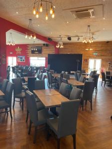 a dining room with wooden tables and chairs at Golden Sands 6 Berth Beach front Ingoldmells beds made up for arrival WIFI in Ingoldmells
